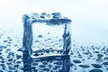 Transparent ice cube with reflection on blue glass with water drops Royalty Free Stock Photo