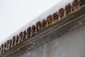 transparent icicles hanging from roof at cold winter day, weather concept Royalty Free Stock Photo