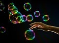 The transparent, iridescent soap bubbles isolated on black.