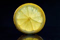 Transparent lemon slice on a dark background.