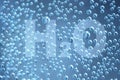 Transparent letters H2O on the background with a lot of water drops Royalty Free Stock Photo