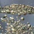 Transparent liquid brimming with numerous small, spherical bubbles. The bubbles are Royalty Free Stock Photo