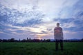 A transparent male hiker with a rucksack with back to camera looking at the sunset in the countryside Royalty Free Stock Photo