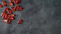 Transparent matte red gel capsules of vitamin and oil on a gray concrete background. The concept of a healthy lifestyle Royalty Free Stock Photo