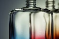 Transparent multi-colored bottles for perfume or liquids on a light background. Without cap. Color diffusion. Selective focus Royalty Free Stock Photo