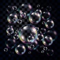 Transparent and multicolored soap bubbles over dark