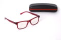 Transparent optical glasses with a eyeglass case on an isolated white background.