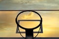 Transparent outdoor basketball hoop against sunset sky background. Low angle close up view Royalty Free Stock Photo