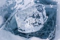 A transparent piece of ice on the blue frozen Lake Baikal Royalty Free Stock Photo