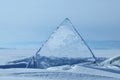 Transparent pieces of ice on the surface of the iced nad snowcaped pond. Baikal lake. Royalty Free Stock Photo