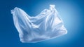 Transparent plastic bag floating against a bright blue background symbolizing pollution and environmental concerns with a focus on Royalty Free Stock Photo