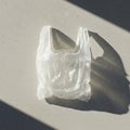 A transparent plastic bag is placed flat on a light gray concrete surface. The bag casts Royalty Free Stock Photo