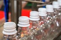 Transparent plastic bottles on the conveyor belt move into water filling machine in the drinking water factory. beverage industry Royalty Free Stock Photo
