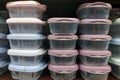 Transparent plastic containers with pink lids on the shelf. Royalty Free Stock Photo