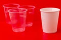 Transparent plastic disposable cups and an eco-friendly paper cup Royalty Free Stock Photo