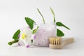 Transparent plastic jar with large flakes of violet lavender marine dead sea salt isolated on clean white background