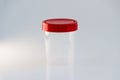 Transparent plastic jar with a red lid on a white background. for analysis Royalty Free Stock Photo