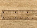 Transparent plastic school ruler on a wooden table. Millimeters and centimeters are marked in black. Measuring length and width