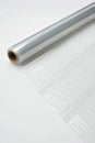 Transparent Plastic Wrap Roll on White Surface, Diagonal Composition, Studio Lighting Royalty Free Stock Photo
