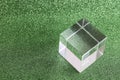 transparent podium for product display on green glittering background.