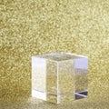 transparent podium for product display on yellow glittering background.