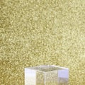 transparent podium for product display on yellow glittering background.