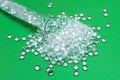 Transparent Polyethylene granules on a green background.The concept of free bpa. HDPE Plastic pellets. Plastic Raw material . ID