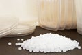 Transparent Polyethylene granules and plastic containers for the Royalty Free Stock Photo
