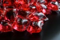 Transparent red gel capsules for washing machines lie on the black of an anti-virus detergent company. Macro Royalty Free Stock Photo