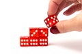 Transparent and red glass dices in hand on white background