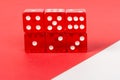 Transparent and red glass dices isolated on red and white background