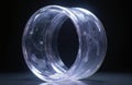 Transparent ring object with internal light glow. Abstract shape design on dark background. Smooth curve structure, clean glass Royalty Free Stock Photo