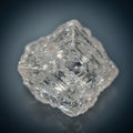 A transparent, rough octahedral diamond crystal with intricate, geometric facets. The Royalty Free Stock Photo