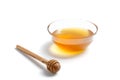 Transparent saucer with honey. A spoon for honey lies on the table. White  background Royalty Free Stock Photo