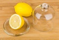 Transparent saucer with lid and lemon on table