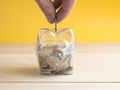 transparent see through piggy bank filled with coins on white background. Royalty Free Stock Photo