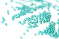 Transparent seed beads aquamarine color scattered on a white surface close-up Royalty Free Stock Photo