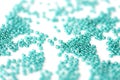 Transparent seed beads aquamarine color scattered on a white surface close-up Royalty Free Stock Photo