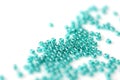 Transparent seed beads aquamarine color scattered on a white surface close-up Royalty Free Stock Photo