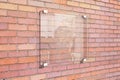 Transparent signboard on red brick wall