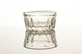 Transparent, small, glass cup on white background.