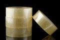 Transparent tape in rolls on a black background Royalty Free Stock Photo