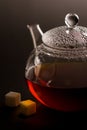 Transparent teapot with black tea and sugar Royalty Free Stock Photo