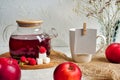 Transparent teapot with red tea with raspberries and apples. Detox antioxidant home health drink. Copy space Royalty Free Stock Photo
