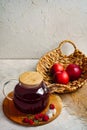 Transparent teapot with red tea with raspberries and apples. Detox antioxidant home health drink. Copy space Royalty Free Stock Photo