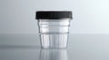 Transparent urine analysis container with black lid. Clear specimen cup on a light backdrop. Concept of urinalysis