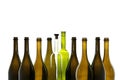 Transparent wine bottle with wine stopper and green wine bottle among brown empty wine bottles isolated on white b Royalty Free Stock Photo