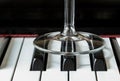 Transparent wine glass leg stand on piano keyboard