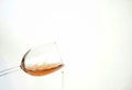 transparent wine glass with spilling liquid on white background Royalty Free Stock Photo