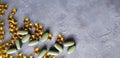 Transparent yellow gel capsules and green tablets on a grey concrete background. The concept of a healthy lifestyle Royalty Free Stock Photo